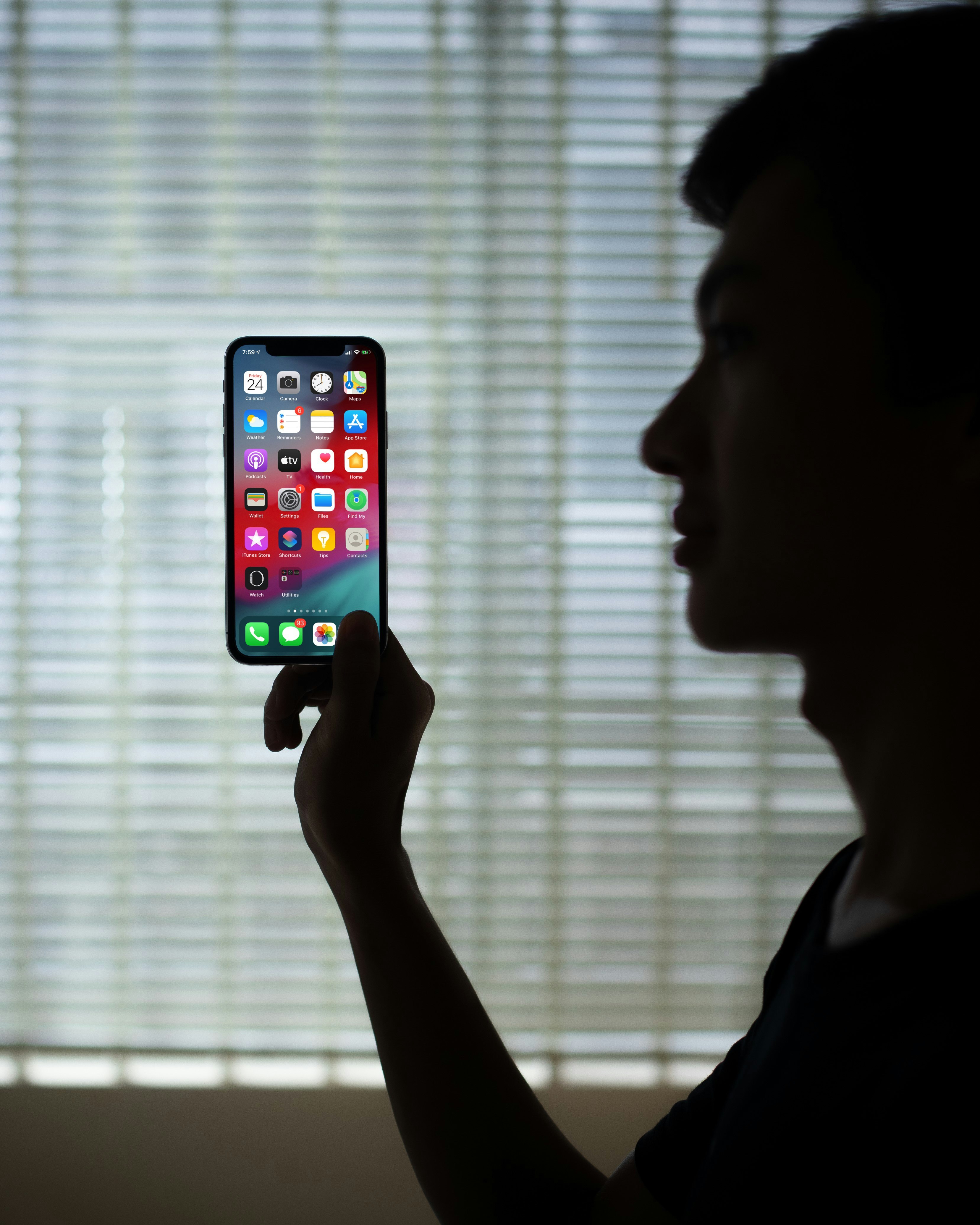 person holding iphone 6 with black case